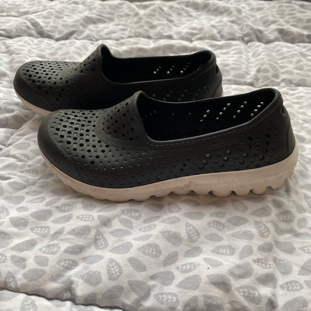 Black and white girls Skechers slip-on shoes